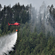 A helicopter drops water at a wildfire next to the village Grotingen in Bracke municipality in central Sweden on July 22, 2018.